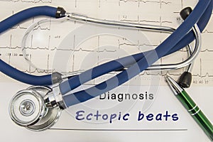 Diagnosis of Ectopic beats. Stethoscope and recorded electrocardiogram  on paper lying horizontally inscription diagnosis Ectopic photo