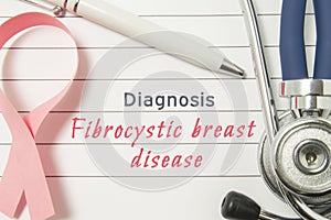 Diagnosis Fibrocystic breast disease. Pink ribbon as symbol of struggle with breast oncology and disorders and stethoscope lying o