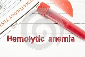 Diagnosis Hemolytic Anemia. Notepad with text labels Hemolytic Anemia, laboratory test tubes for the blood, blood smear for micros