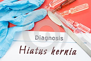 Diagnosis Hiatus hernia. Blue gloves, surgical scalpel, syringe and ampoule with medicine lie next to inscription Hiatus hernia. C