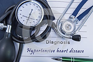 Diagnosis Hypertensive heart disease. A stethoscope, sphygmomanometer with a cuff lie on medical form documentation with diagnosis