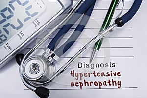 Diagnosis Hypertensive nephropathy. Stethoscope and electronic sphygmomanometer lie on medical paper form with cardiac diagnosis H