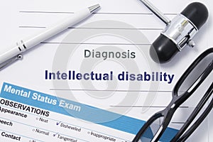 Diagnosis Intellectual Disability. Medical note surrounded by neurologic hammer, mental status exam with an inscription in large l photo