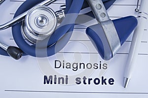 The diagnosis of mini stroke TIA. Paper medical history with diagnosis of mini stroke, on which lie stethoscope, neurological ha