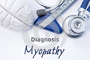 Diagnosis of Myopathy. Anatomical brain figure, neurological hammer and stethoscope lying on sheet of paper or book with the title photo