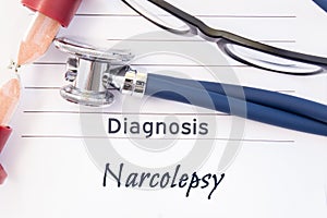 Diagnosis Narcolepsy. Psychiatric diagnosis Narcolepsy is written on paper, on which lay stethoscope and hourglass for measuring t