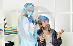 Diagnosis of pneumonia. Sars concept. Doctor protective equipment examines patient suspected coronavirus infection