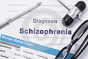 Diagnosis Schizophrenia. Medical note surrounded by neurologic hammer, mental status exam with an inscription in large letters psy