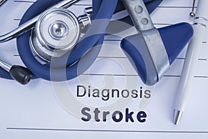 The diagnosis of stroke. Paper medical history with diagnosis of stroke, on which lie blue stethoscope, neurological hammer and pe