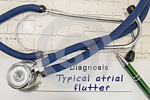 Diagnosis of Typical atrial flutter. Stethoscope and recorded electrocardiogram on paper lying horizontally inscription diagnosis