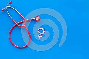 Diagnostic and cure of gynaecological disease with stethoscope and female symbol on blue background top view mock-up