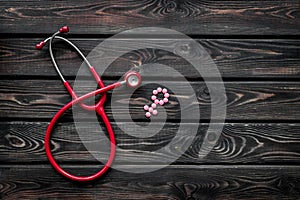 Diagnostic and cure of gynaecological disease with stethoscope and female symbol on wooden background top view mock-up