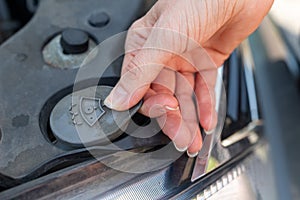 Daily diagnostics of the car by the driver. Refilling car washer fluid