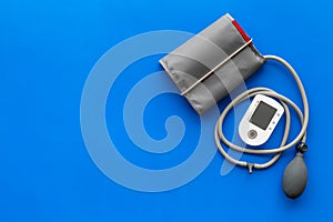 Diagnostics of cardiac disease with pulsimeter on blue background top view copyspace