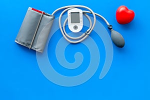 Diagnostics of cardiac disease with pulsimeter on blue background top view copyspace