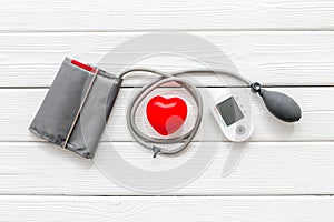 Diagnostics of cardiac disease with pulsimeter on white wooden background top view