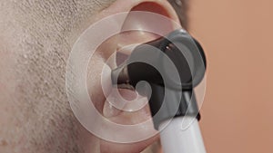 Diagnostics and examination of the patient's ear for the presence of diseases in otolaryngology, macro. Otoscope