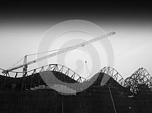 Diagonal black and white construction crane city background