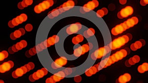 Diagonal blurred bokeh circles. Motion animation of blurred circles in red, orange and yellow colors on a black background.