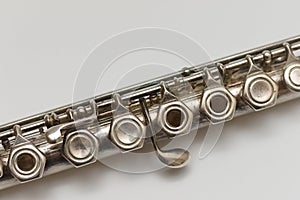 Diagonal close-up image of flute buttons on white background
