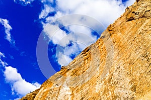 Diagonal figure of sandstone cliff against sky