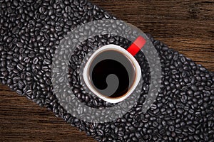 Diagonal line of coffee beans with cup