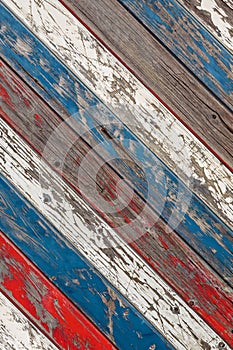 Diagonal old planks painted white, red and blue