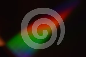 Diagonal rainbow flare cutting through a dark frame