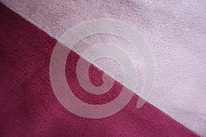 Diagonal seam between pink and red artificial suede