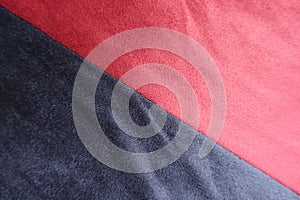 Diagonal seam between red and blue artificial suede