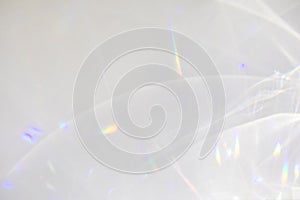 Diagonal shadow and rays of light on a white wall