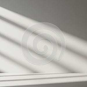 Diagonal shadows from blinds cast across a smooth, light gray surface. The shadows