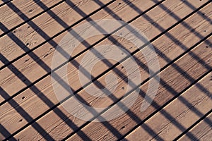 Diagonal shadows on wood plank floor, background