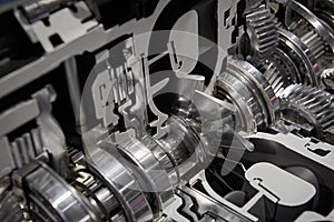 Diagonal view on cross section of commercial truck gearbox with shaft gear wheels bearings seals and cooling fan turbine bla