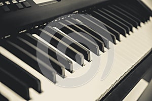 Diagonal view of piano or organ keys. Black and white closeup