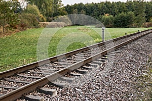 Diagonale railroad track through countryside photo