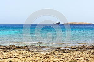 Diakofti port at the Greek island of Kythira. The shipwreck of the Russian boat Norland in a distance