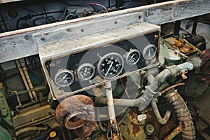 Dial gauge dashboard of a diesel engine in a engine room of a boat showing RPM and measurements