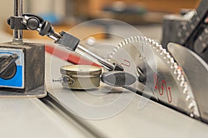 Dial indicator with magnetic base. Shaft vibration measurement, setting and balancing of cutting disc for woodworking machines