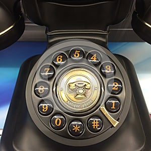 Dial numbers of Antique phone with relief of retro phone