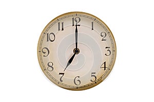 The dial of an old vintage clock. Seven o'clock on the clock
