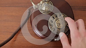 Dialing numbers with an old vintage brown telephone