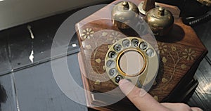 Dialing on an old rotary style telephone.