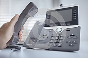 Dialing a telephone in the office concept for communication, contact us and customer service support