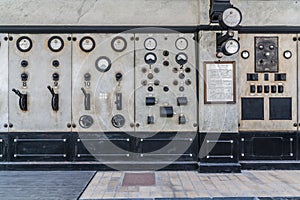 Dials and switches in the control room in old power plant. Control panel with measuring instruments