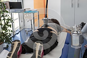 Diamagnetic Pump for Pain Therapy: Woman lying on aBed Undergoing Therapy