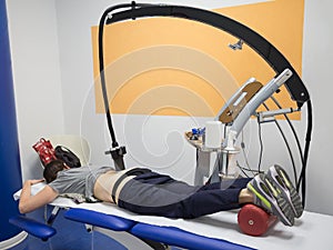 Diamagnetic Pump for Pain Therapy: Woman lying on aBed Undergoing Therapy