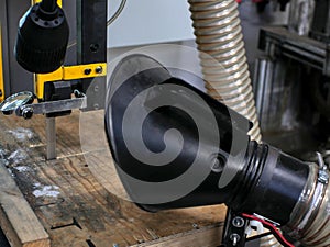 Diamond band saw blade. In blurred foreground, a dust extraction device