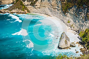 Diamond beach with coconut palms and cliff in Nusa Penida, Indonesia