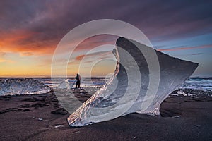 Sunrise at Diamond beach, near Jokulsarlon glacier lagoon, with a photographer